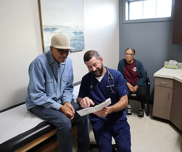 Dr. Jay Marque Standing in front of a Lake Charles Primary Care sign