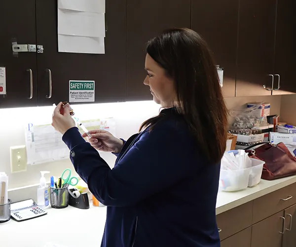 Dr. Jay Marque Standing in front of a Lake Charles Primary Care sign